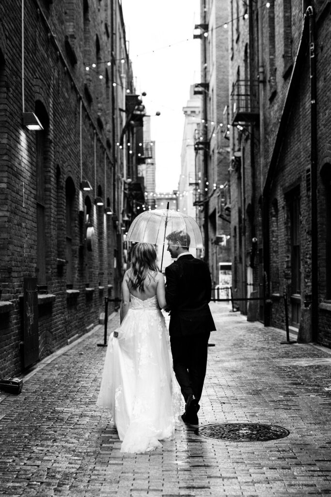 bride and groom walk through city during pacific northwest elopement