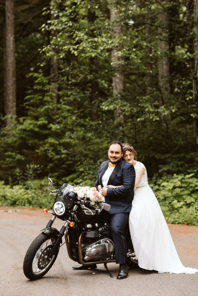 bride and groom sit on a motorcycle to gether