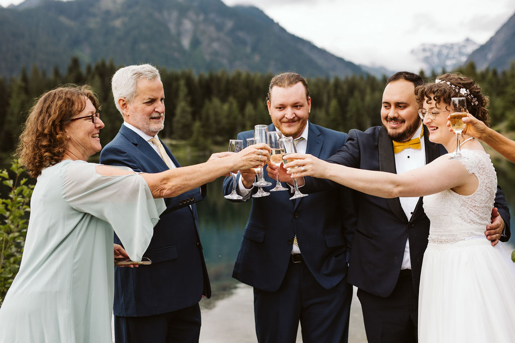 bride and groom cheers with guests