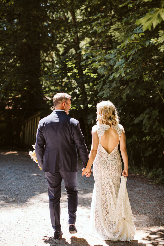 bride and groom walk holding hands