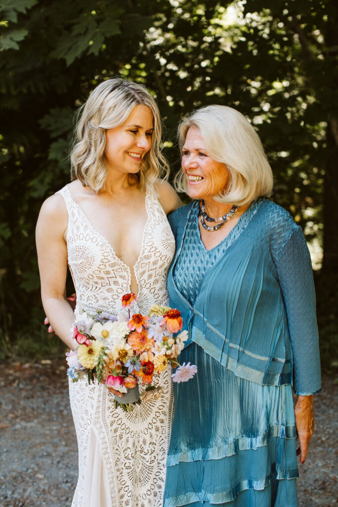 bride and older woman smile at each other