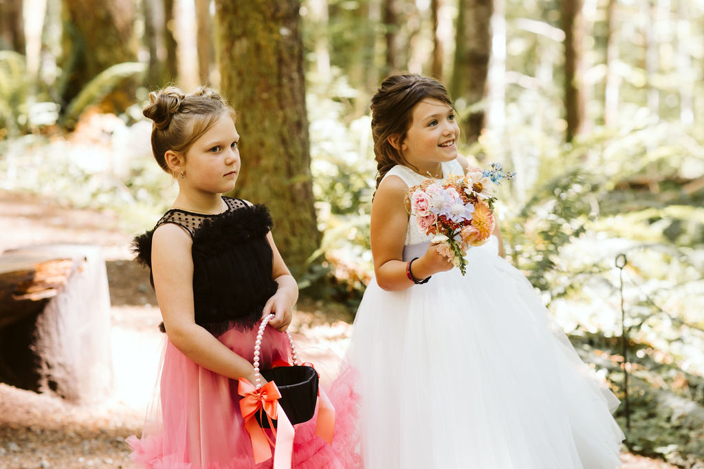 two little girls in the woods wearing dresses