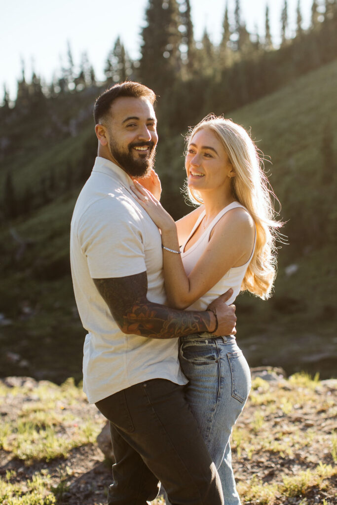 boy and girl laugh at mt rainier engagement session