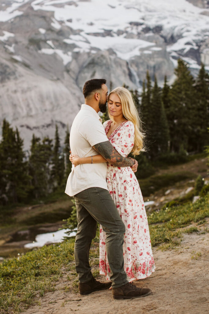 boy snuggles into girls hair at mt rainier engagement session