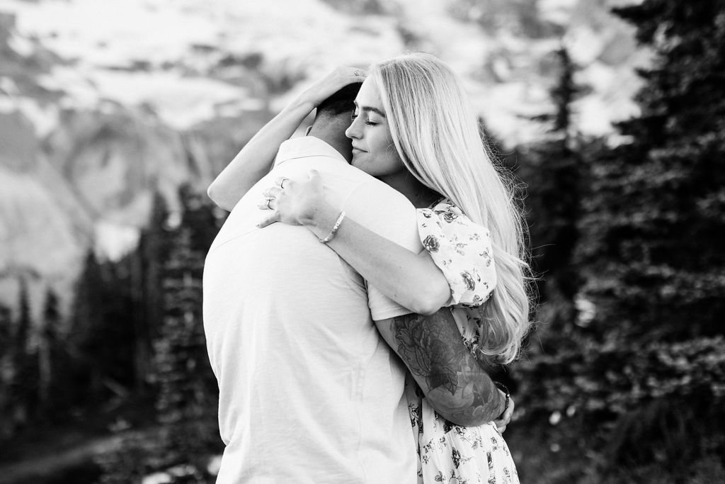 girl cradles boys head to her chest at mt rainier engagement session