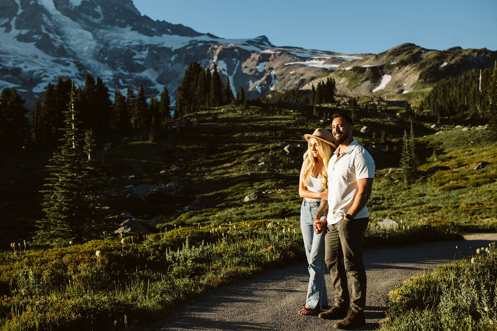 boy and girl look into the sun at mt rainier engagement session
