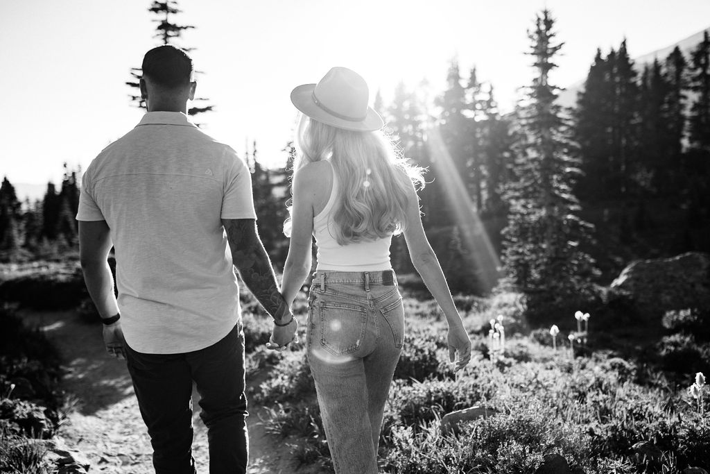 boy and girl walk into a sun  beam at mt rainier engagement session