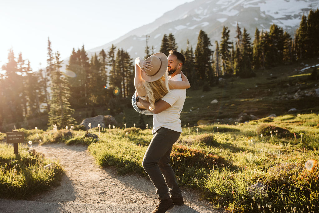 boy holds girl in his arms at mt rainier engagement session