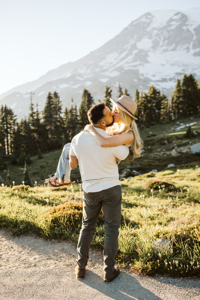 boy holds girl in his arms at mt rainier engagement session