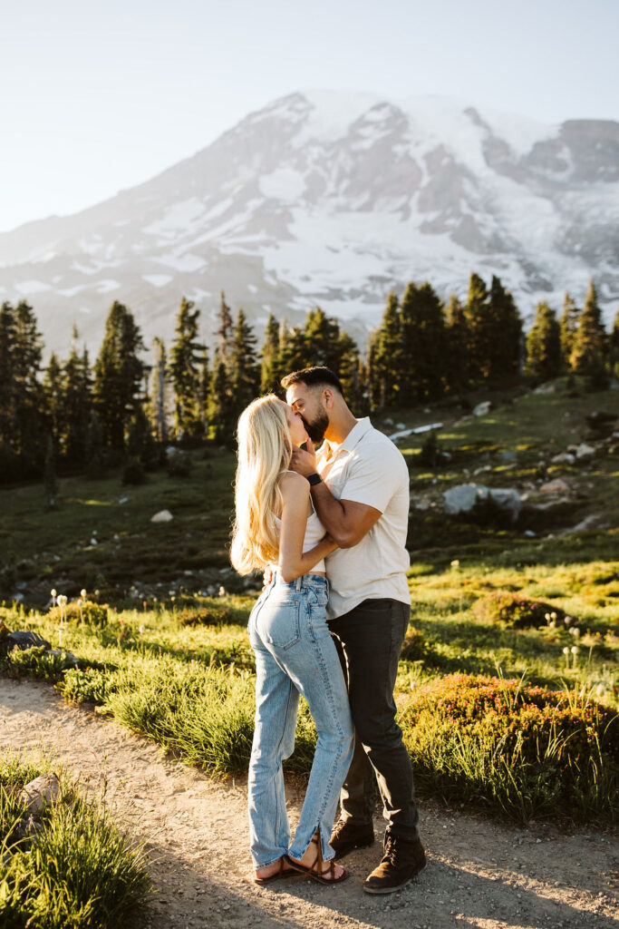 boy and girl kiss at mt rainier engagement session