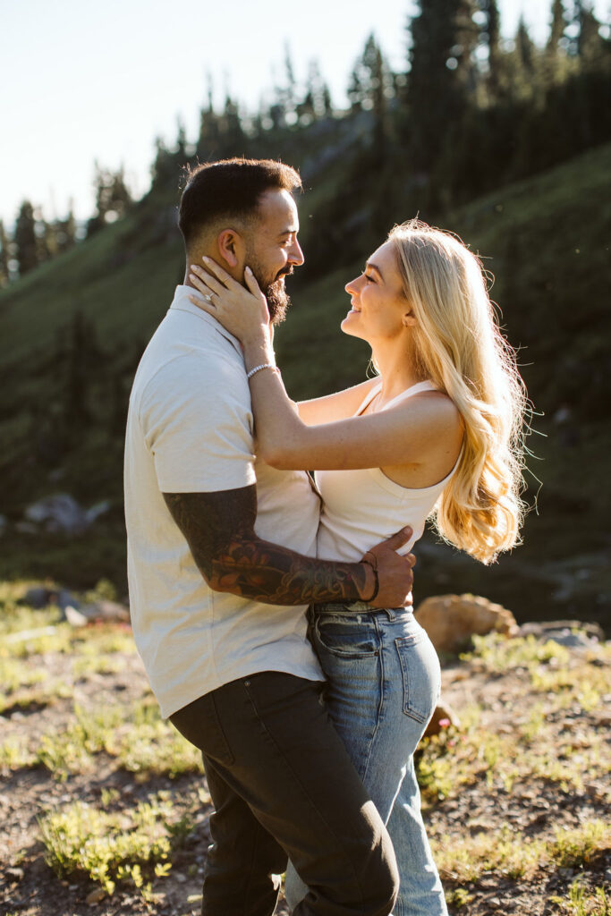 boy and girl hold each other at mt rainier engagement session