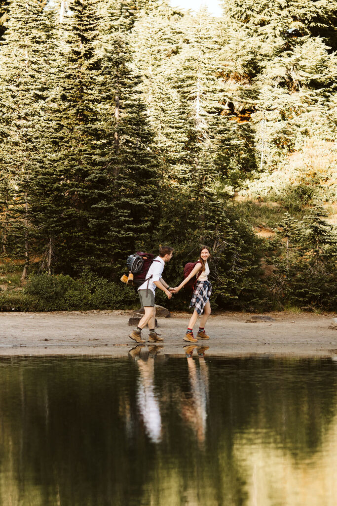 boy and girl walk on path during mt rainier engagement session
