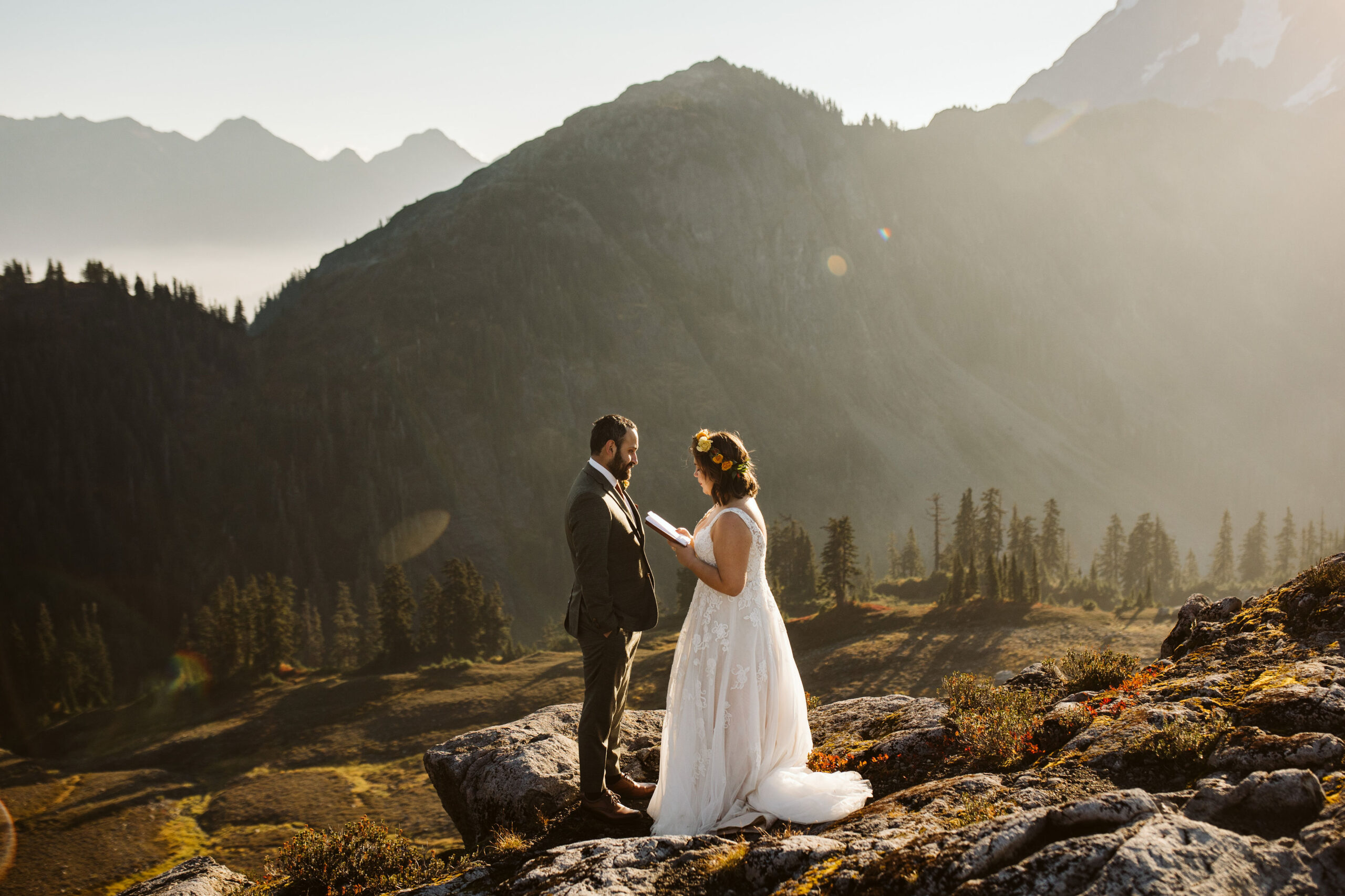 bride and groom read vows to each other atop mt baker