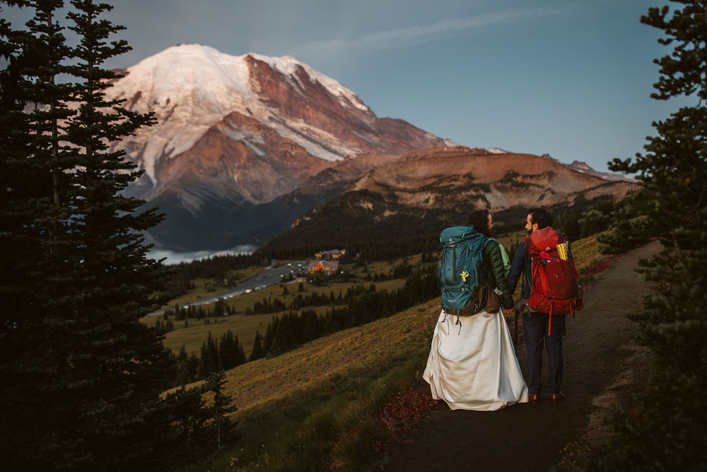 bride and groom hiking on mt rainier