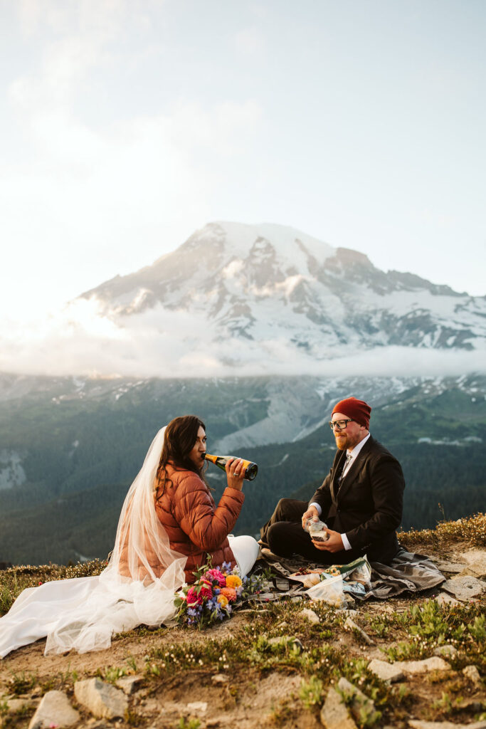 bride and groom picnic with mt rainier in background