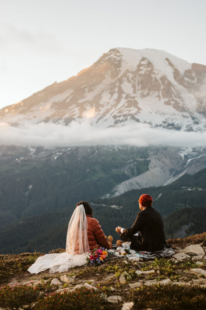 bride and groom picnic with mt rainier in background