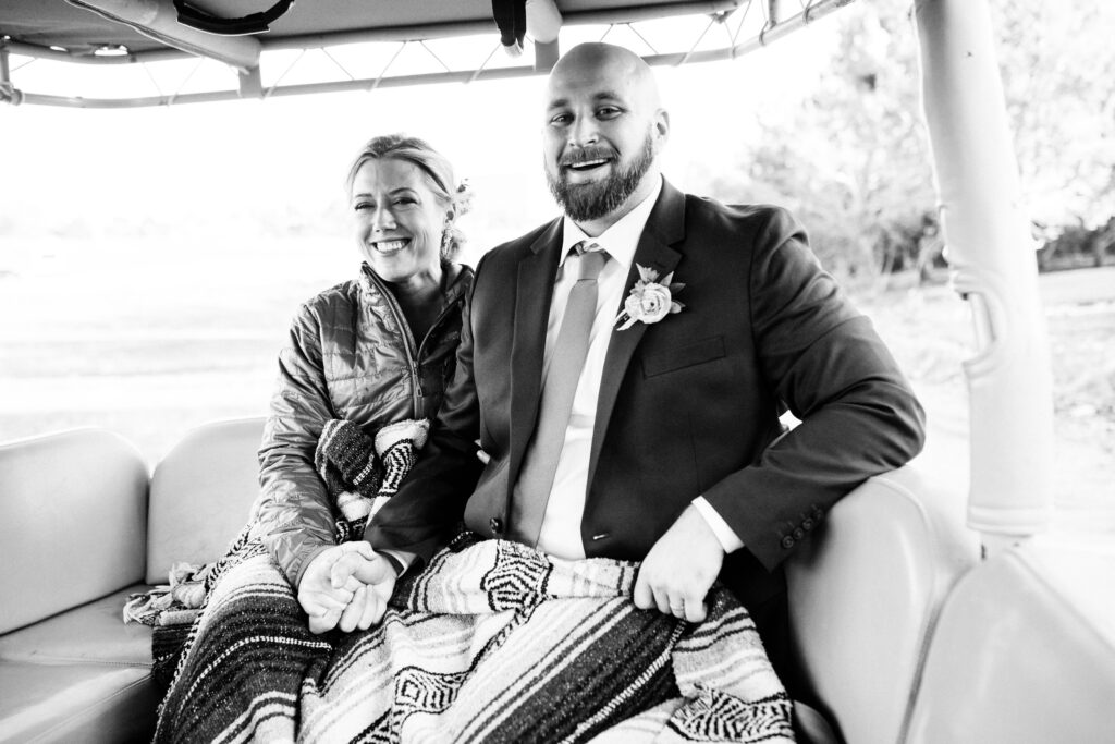 man and woman sit in off road jeep